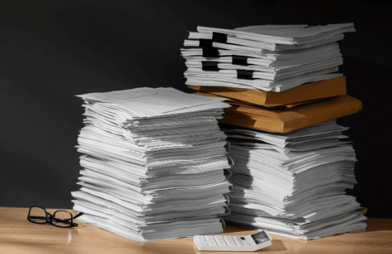 Stack of research documents and papers representing clinical studies and documentation